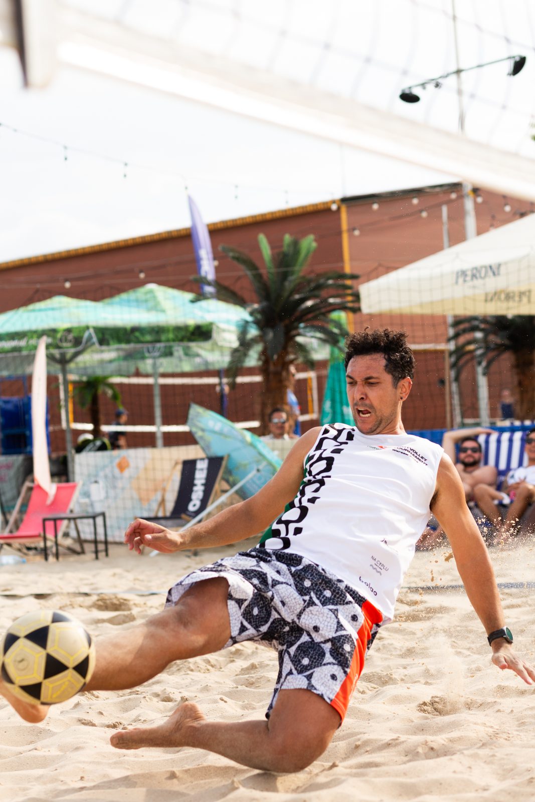 Footvolley player striking the ball