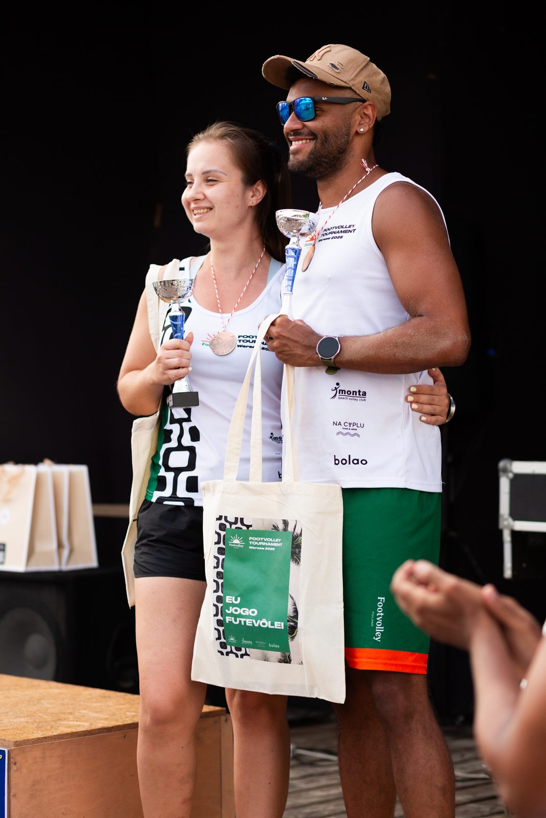 Footvolley Poland players holding the Brazilian flag
